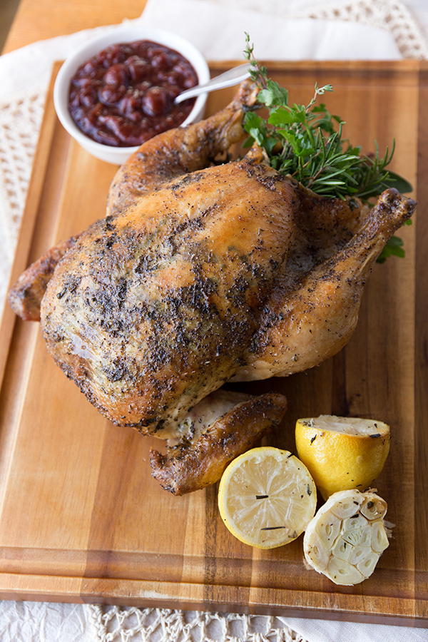 Whole Herb Roasted Chicken on cutting board | thecozyapron.com