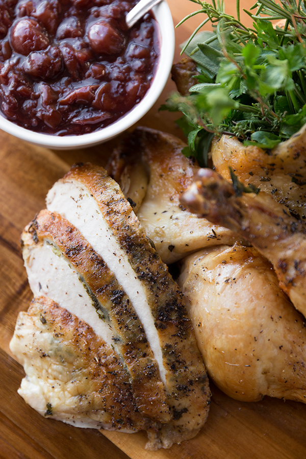 Closeup on succulent slices of Herb Roasted Chicken with cherry compote | thecozyapron.com