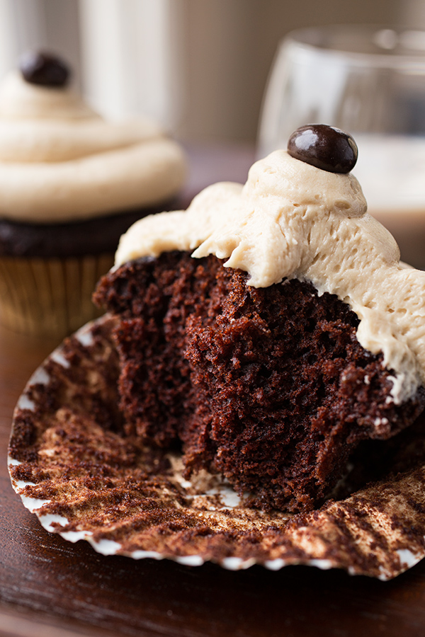 Closeup on an Irish Cream Coffee Cupcake with a bite out of it | thecozyapron.com
