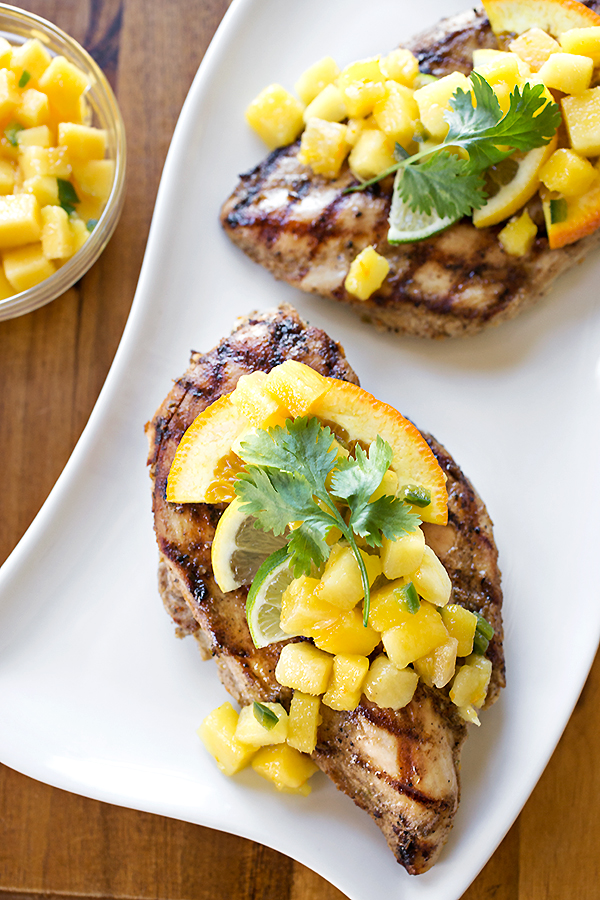 Citrus Chicken with Mango-Pineapple Salsa served on a white platter | thecozyapron.com