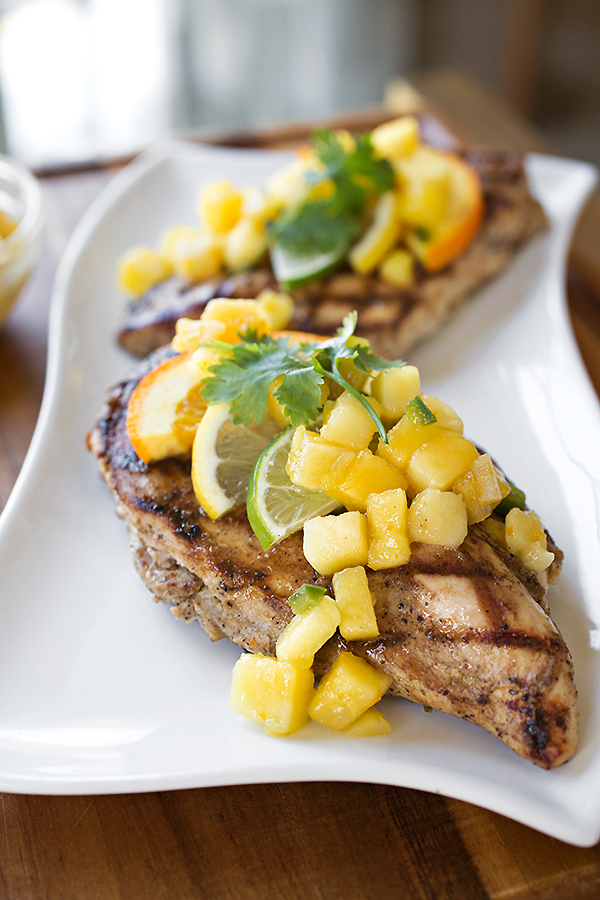 Citrus Chicken with Mango-Pineapple Salsa served on a white platter | thecozyapron.com