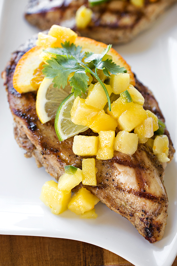 Closeup view of Citrus Chicken with Mango-Pineapple Salsa served on a white platter | thecozyapron.com