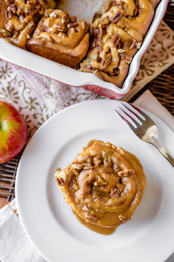 Caramel Apple Cinnamon Rolls on a Plate | thecozyapron.com