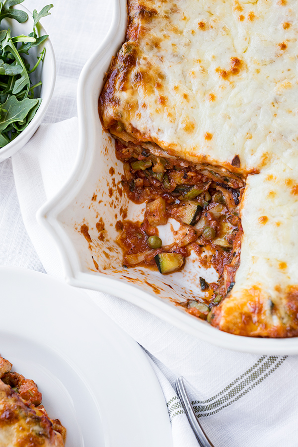 Freshly baked Lasagna Primavera showing layers of colorful vegetables, pasta, and melted cheese | thecozyapron.com