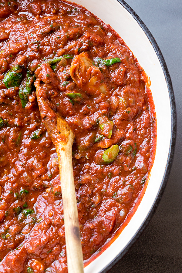 A simmered pot of linguine pasta sauce with sausage and artichoke | thecozyapron.com