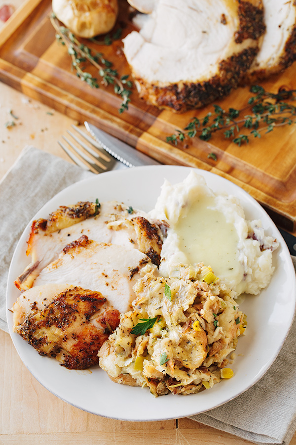 A plate of turkey, mashed potatoes and Herb Stuffing | thecozyapron.com