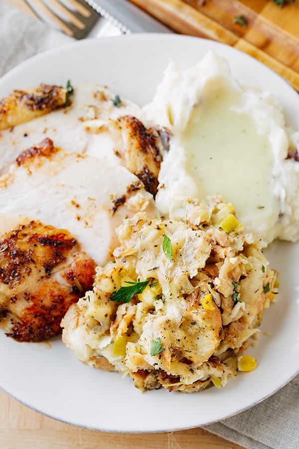 Closeup on a plate of turkey, mashed potatoes and Herb Stuffing | thecozyapron.com