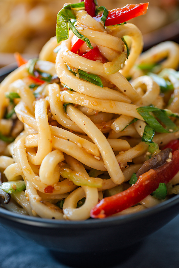 Closeup on Udon Noodles with Garlic and Sesame wrapped around chopsticks | thecozyapron.com