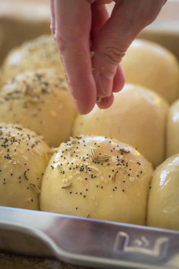 Sprinkling Homemade Rolls with Everything Seasoning | thecozyapron.com