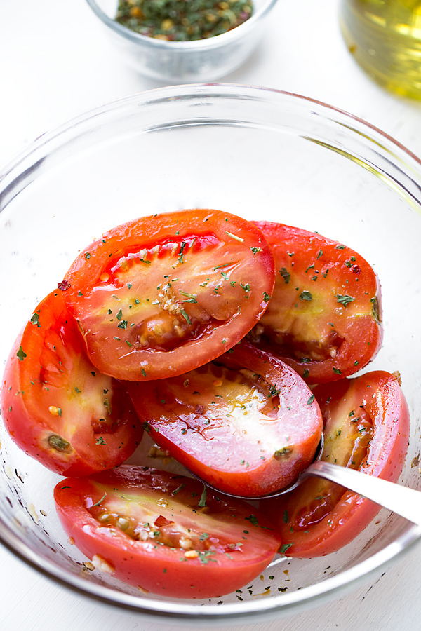 Fresh tomatoes with a sprinkle of herbs, ready for roasting | thecozyapron.com