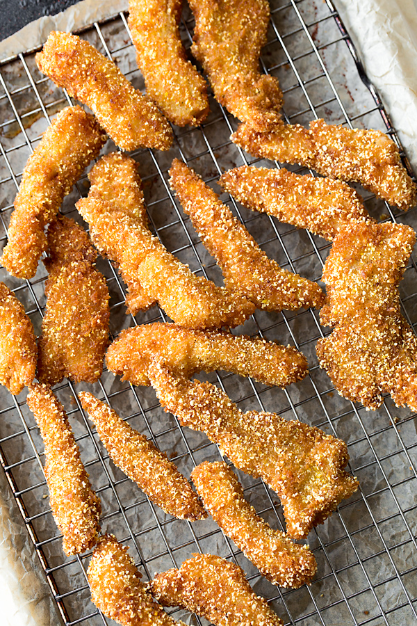 Freshly Fried Fish Sticks on a Wire Rack | thecozyapron.com