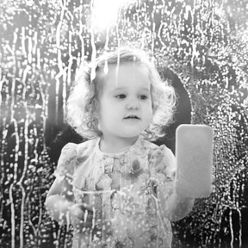 Little girl washing window | thecozyapron.com