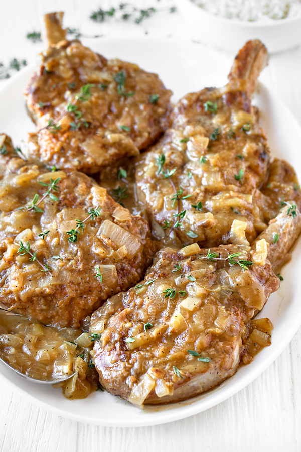 Smothered Pork Chops in a Savory Pan Sauce | thecozyapron.com