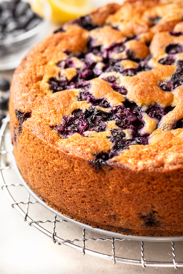 Lemon Blueberry Cake Cooling on a Rack | thecozyapron.com