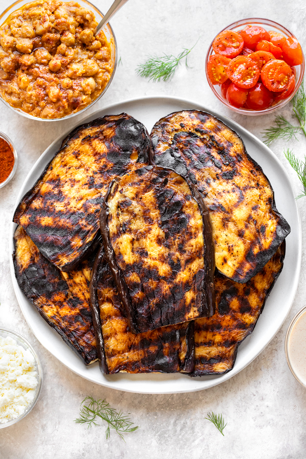Grilled Eggplant with Spicy Chickpeas, Charred Tomatoes, Feta, Garlic Tahini Sauce | thecozyapron.com