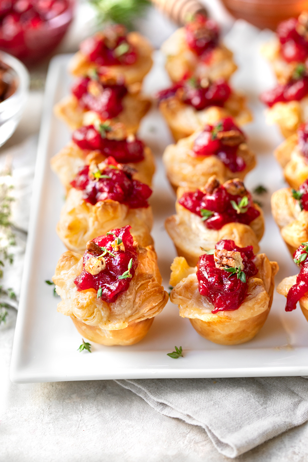 Cranberry Brie Puff Pastry Bites on a Platter | thecozyapron.com