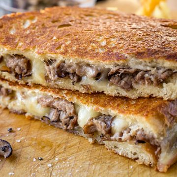Steak and Mushroom Grilled Cheese sliced in half | thecozyapron.com
