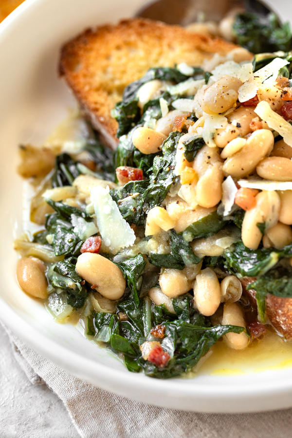 Closeup of Beans and Greens over Toasted Garlic Bread | thecozyapron.com