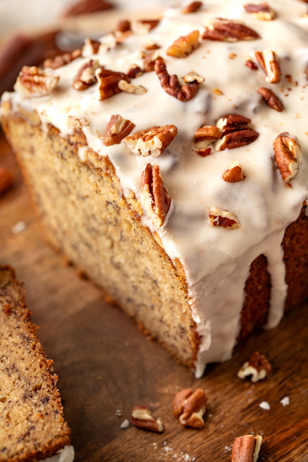Close-up of sliced Buttered Pecan Banana Bread showing the moist texture and brown butter icing