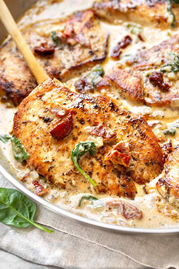 A spoonful of freshly-made Tuscan Chicken, straight from the skillet | thecozyapron.com